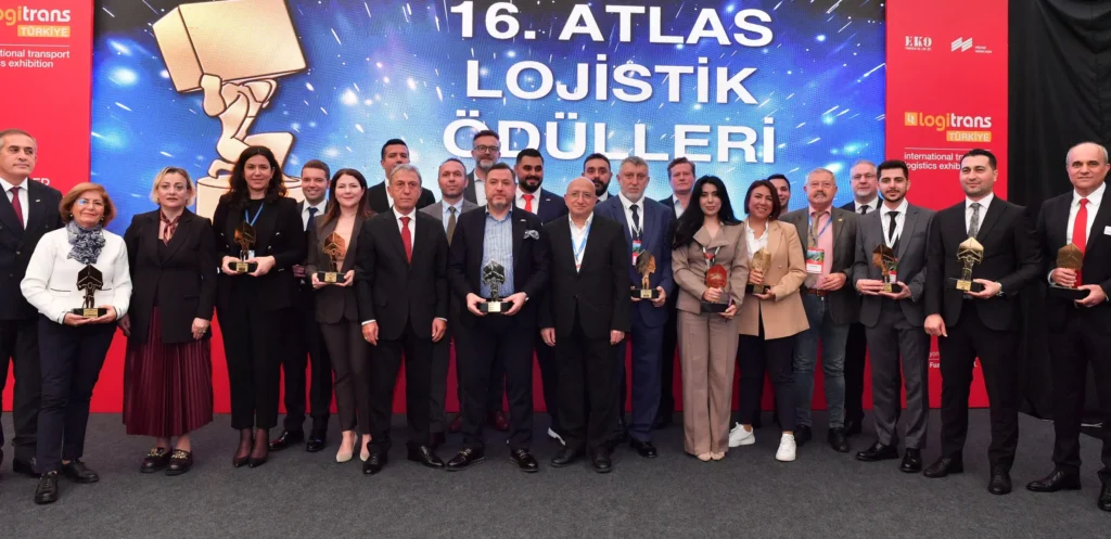 Group photo of award recipients on stage during the 16th ATLAS Logistics Awards ceremony, with the event backdrop in the background.