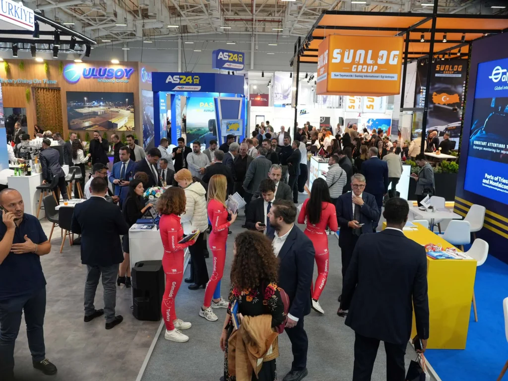 Busy exhibition hall at logitrans 2025 with visitors networking and holding meetings at exhibitor stands.